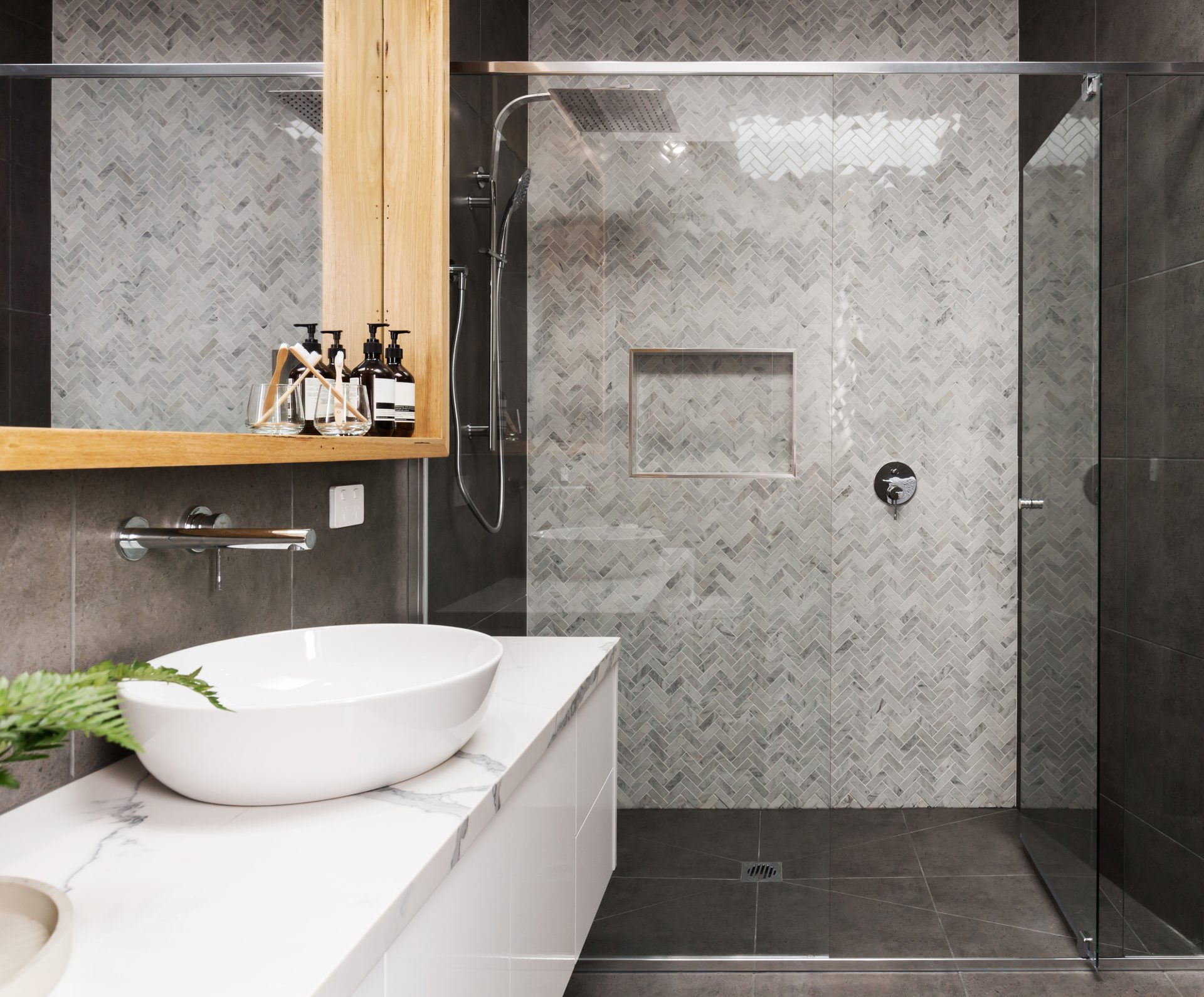 marble mosaic herringbone tiled shower feature in a contemporary ensuite bathroom